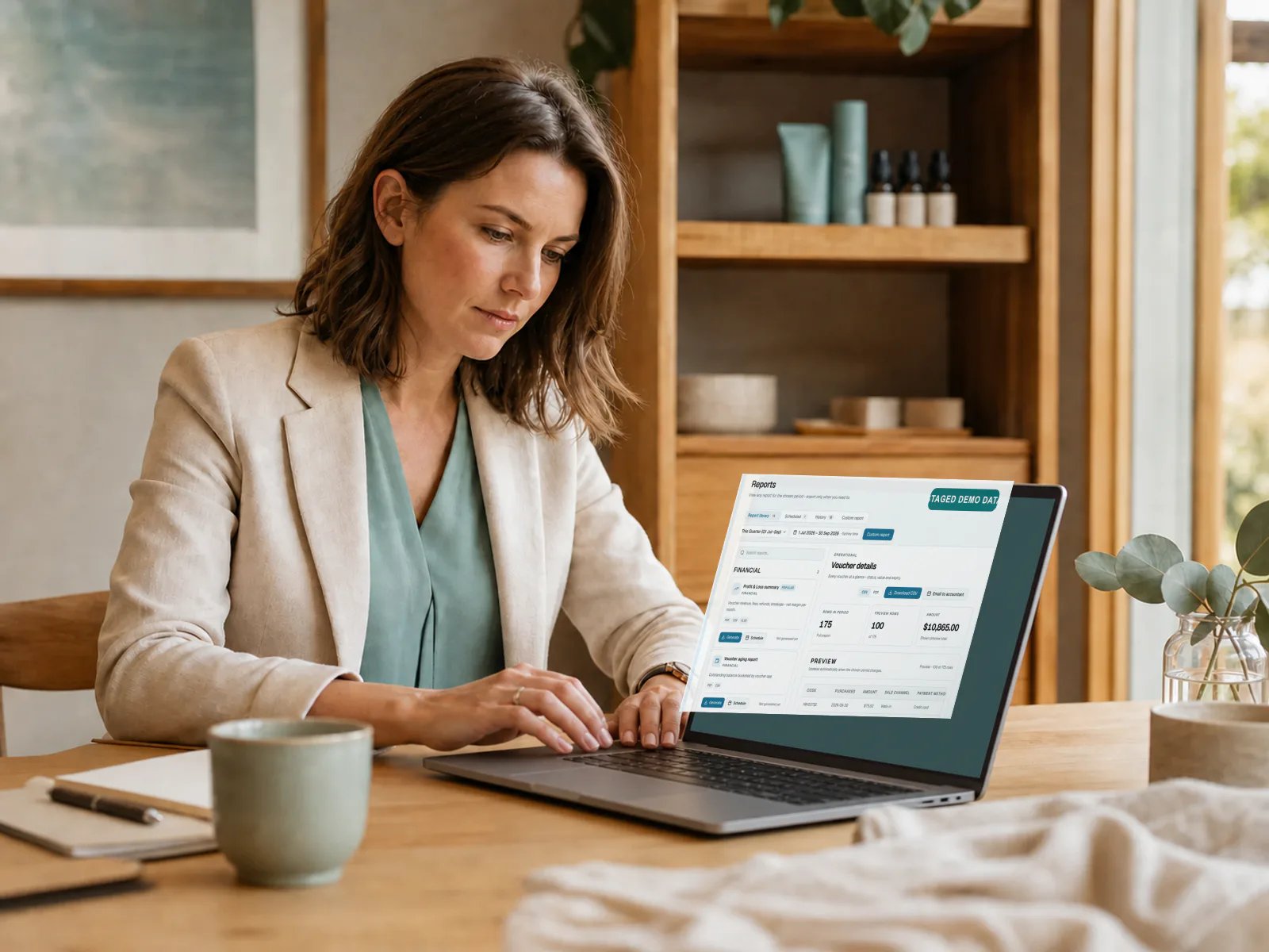 Accountant reviewing a VoucherGrid report with clearly labelled staged demo data.